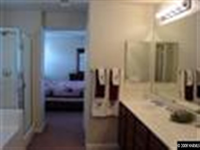 8983 Mahon Drive Reno, NV 89506 - Photo 6 of 8 a bathroom with a sink and a mirror