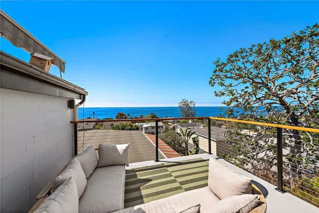 a view of roof deck with furniture and wooden floor