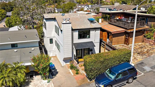an aerial view of a house with a yard