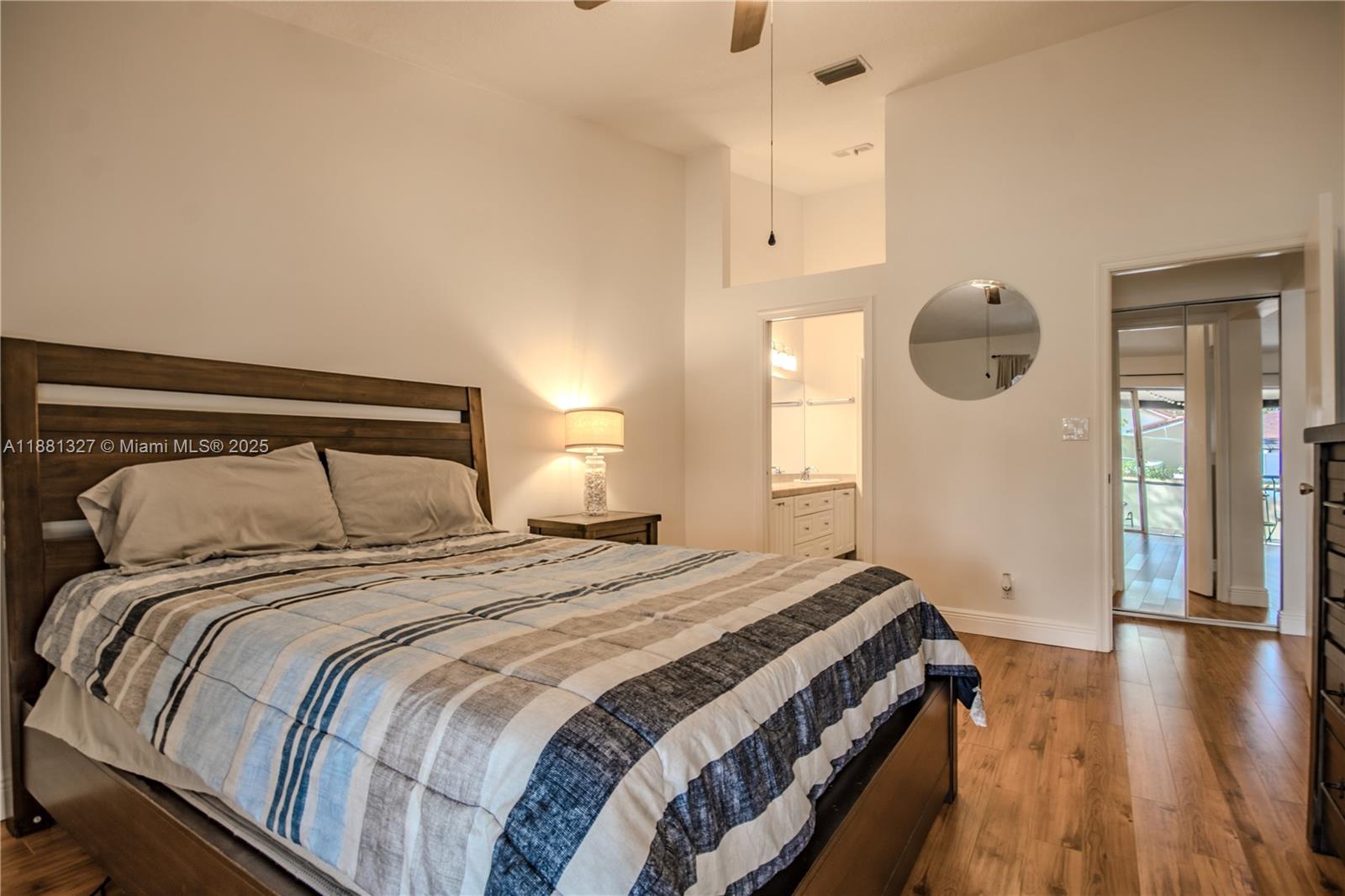 7652 Pinewalk Drive South, Unit 139 Margate, FL 33063 - Photo 15 of 26 a bedroom with a bed and wooden floor