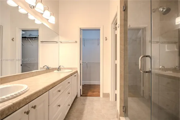a spacious bathroom with a granite countertop sink mirror and a