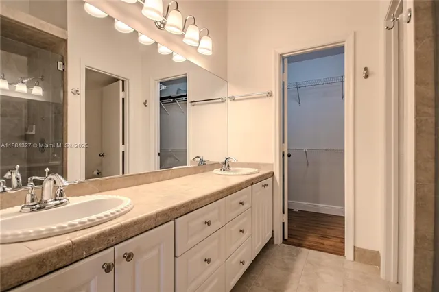 a bathroom with a granite countertop sink mirror and double