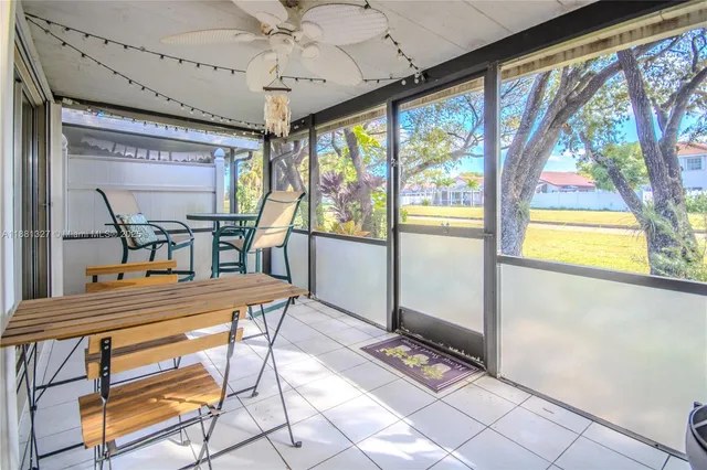 a dining room with furniture a flat screen tv and outdoor view