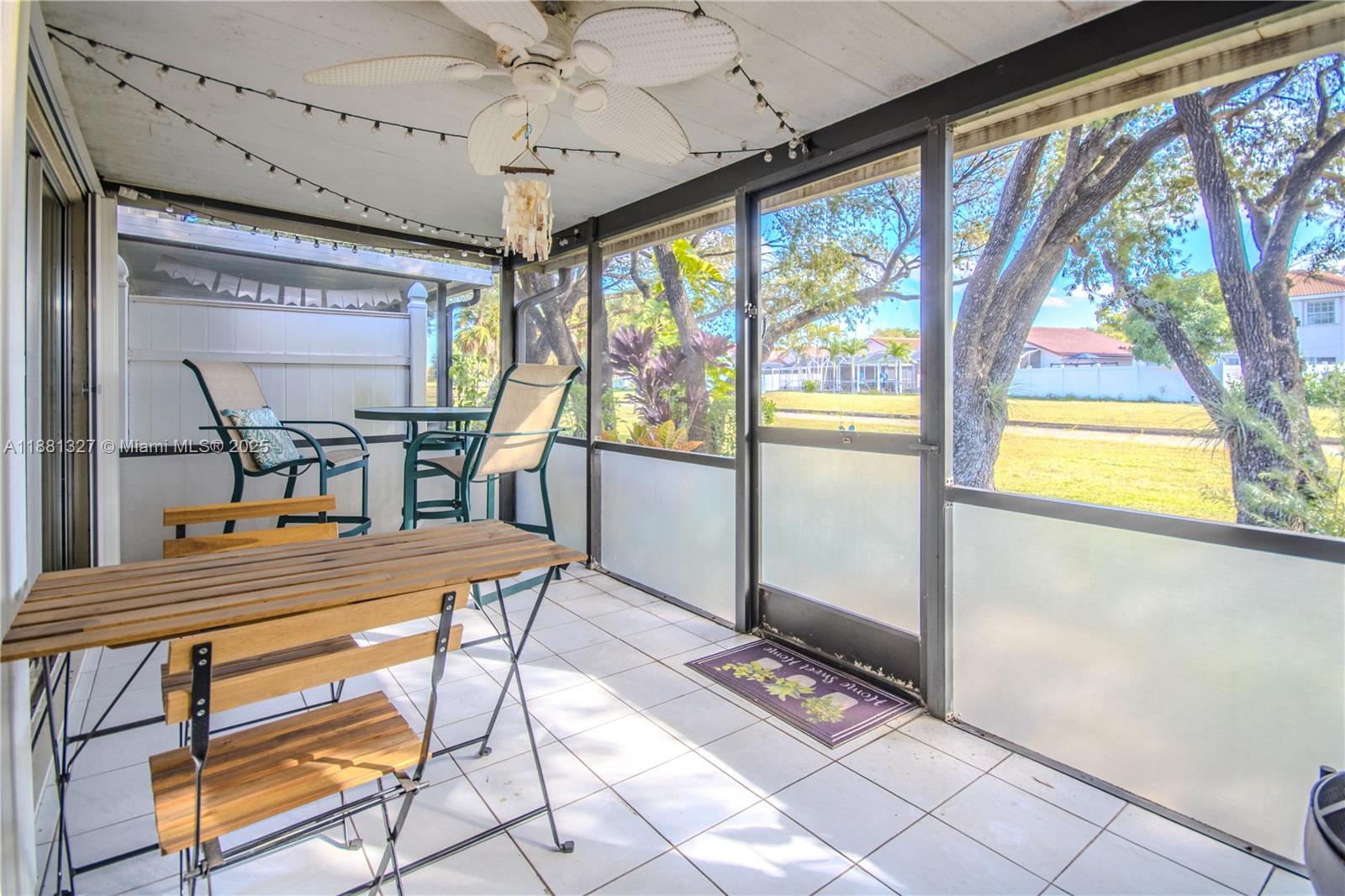 7652 Pinewalk Drive South, Unit 139 Margate, FL 33063 - Photo 20 of 26 a dining room with furniture a flat screen tv and outdoor view