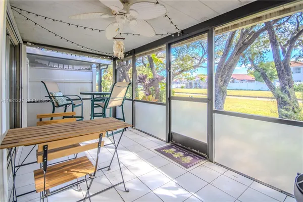 a dining room with furniture a flat screen tv and outdoor view