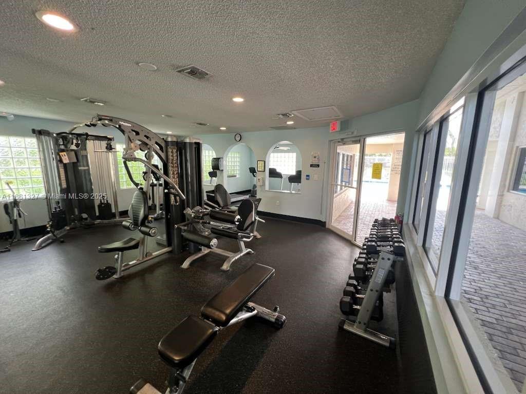 7652 Pinewalk Drive South, Unit 139 Margate, FL 33063 - Photo 23 of 26 a view of a room with gym equipment