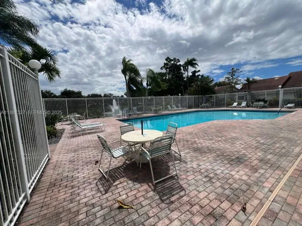 a view of a backyard with furniture and a garden