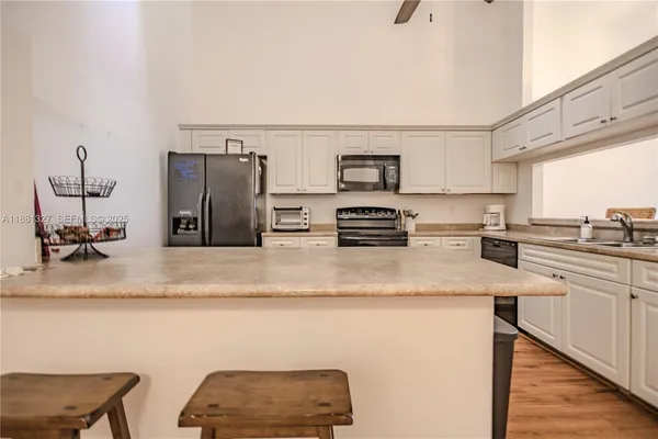 a kitchen with stainless steel appliances granite countertop a sink refrigerator and stove