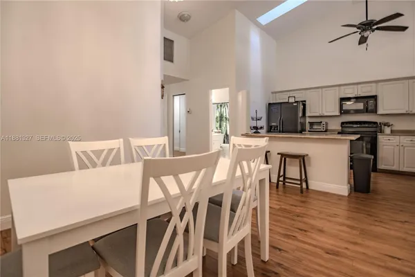 a view of a dining room with furniture and wooden floor