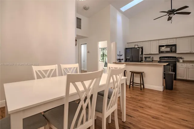a view of a dining room with furniture and wooden floor
