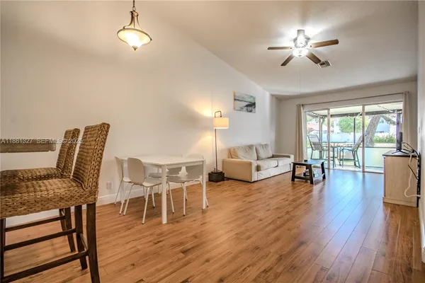 a living room with furniture and a wooden floor