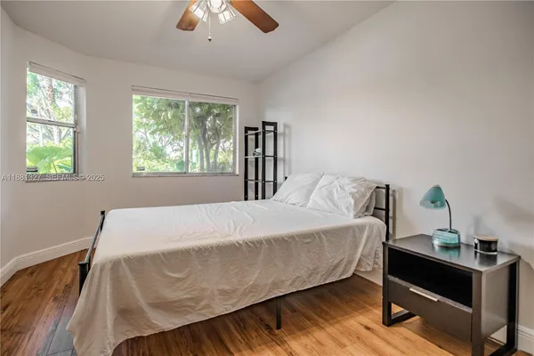 a bed sitting in a bedroom next to a window