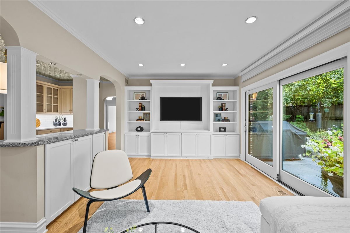 299 Vernon Avenue Glencoe, IL 60022 - Photo 12 of 42 a living room with furniture a flat screen tv and floor to ceiling windows