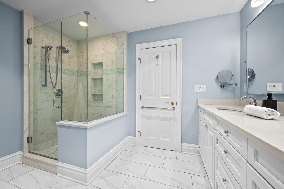 299 Vernon Avenue Glencoe, IL 60022 - Photo 23 of 42 a bathroom with a shower sink and mirror