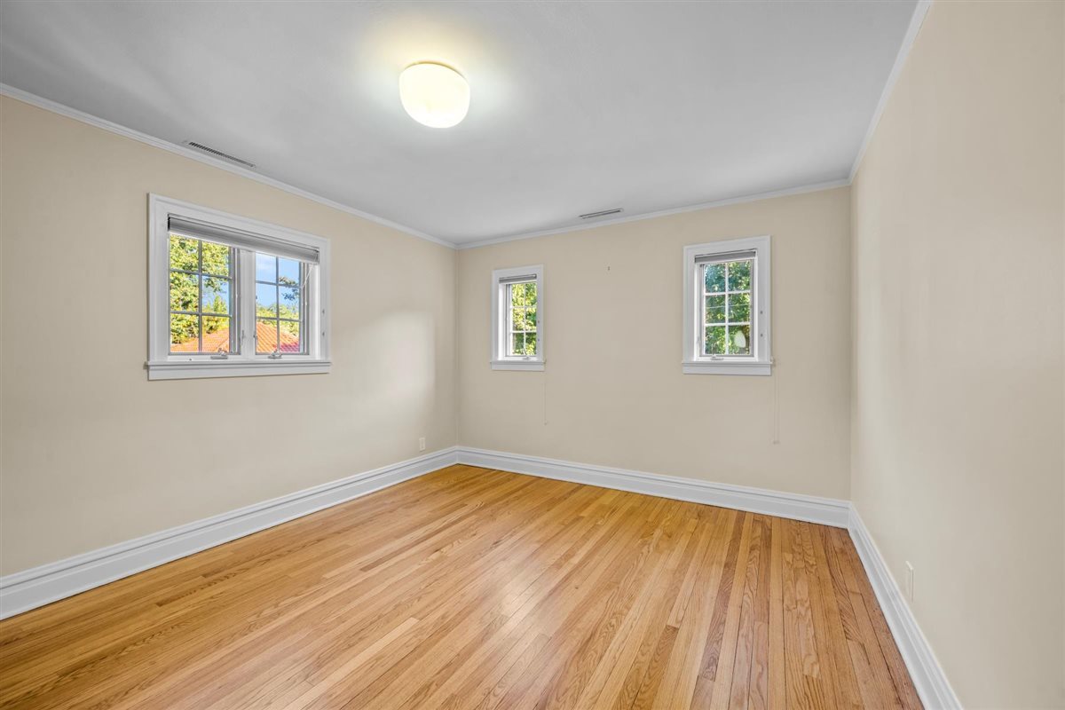 299 Vernon Avenue Glencoe, IL 60022 - Photo 24 of 42 a view of an empty room with wooden floor and a window