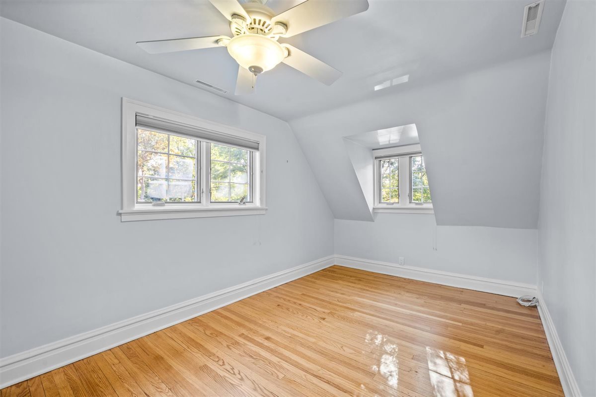 299 Vernon Avenue Glencoe, IL 60022 - Photo 27 of 42 a view of empty room with wooden floor and fan