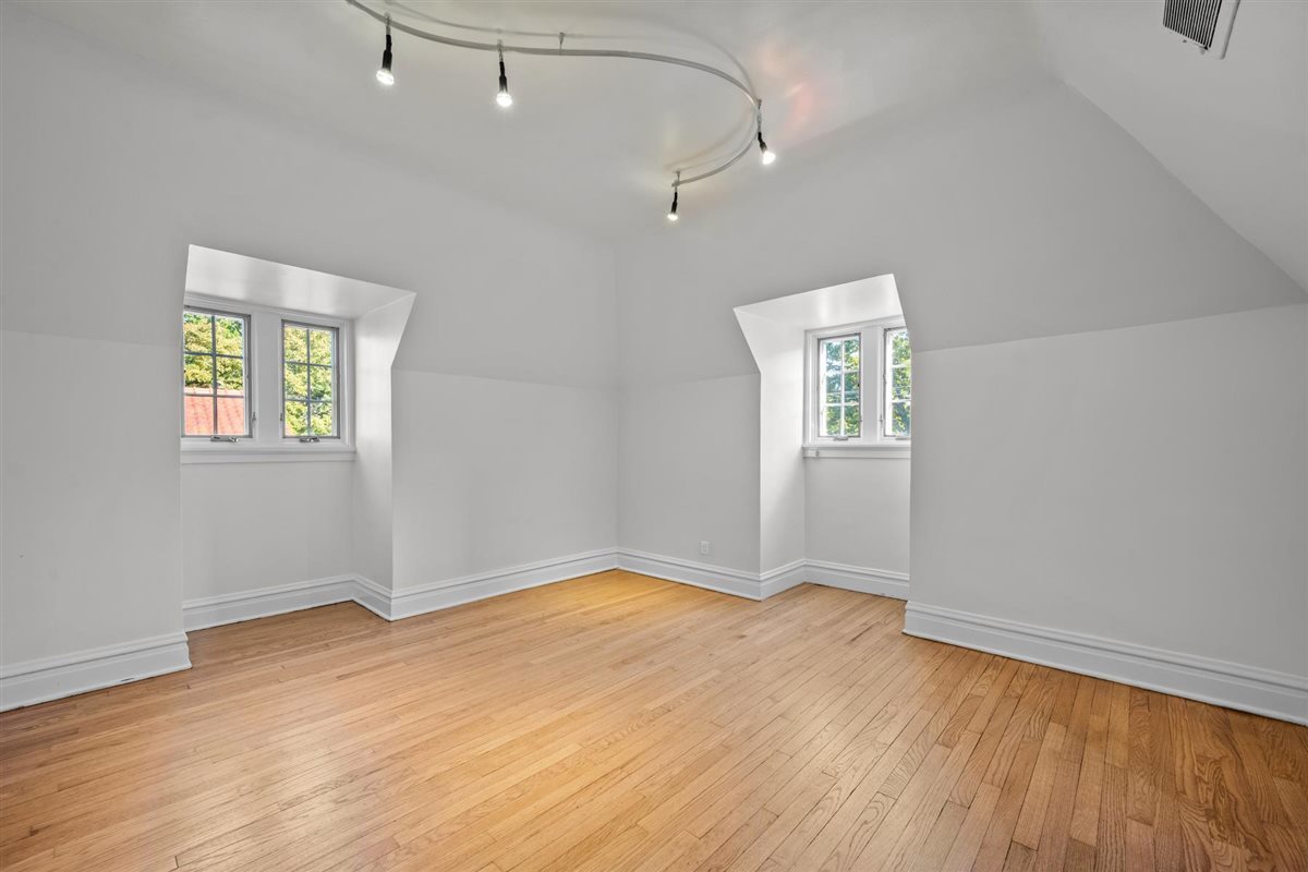 299 Vernon Avenue Glencoe, IL 60022 - Photo 30 of 42 an empty room with wooden floor and windows