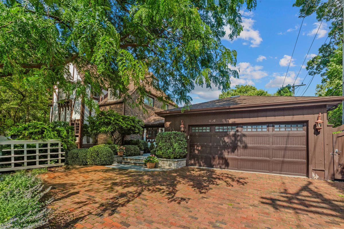 299 Vernon Avenue Glencoe, IL 60022 - Photo 3 of 42 a front view of a house with a yard and garage