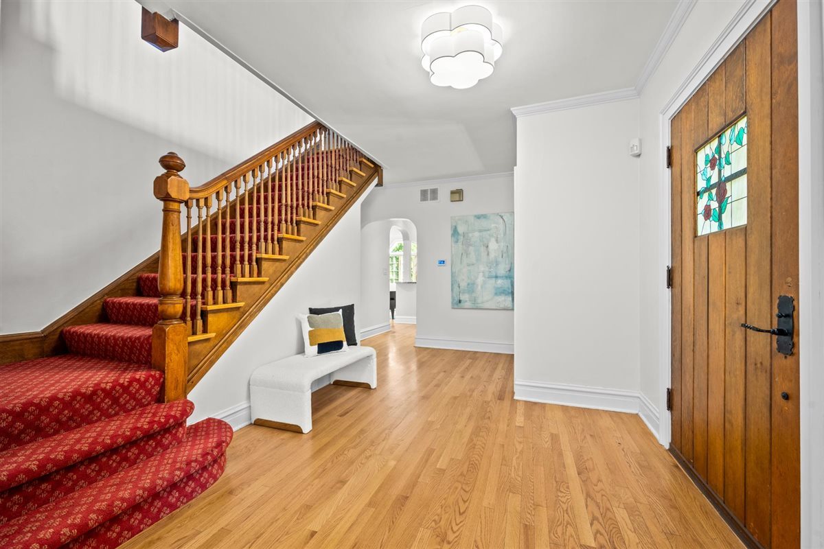 299 Vernon Avenue Glencoe, IL 60022 - Photo 4 of 42 a view of staircase with wooden floor and a rug