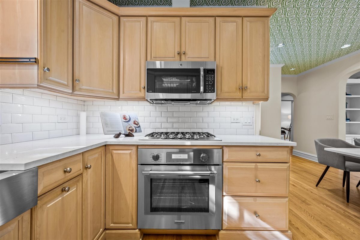 299 Vernon Avenue Glencoe, IL 60022 - Photo 8 of 42 a kitchen with granite countertop a stove top oven a sink and dishwasher