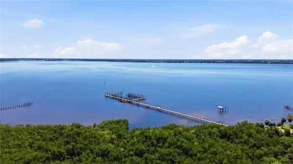 an aerial view of a house with yard and outdoor seating