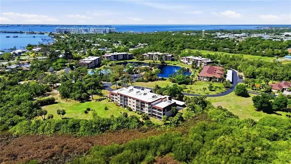 an aerial view of residential houses with outdoor space and trees