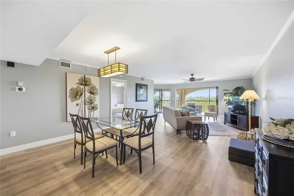 a view of a dining room with furniture window and wooden floor