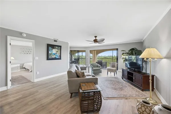 a living room with furniture and a floor to ceiling window