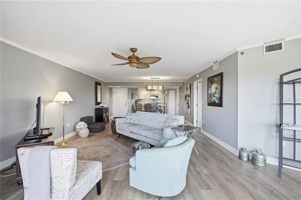 a living room with furniture and a wooden floor