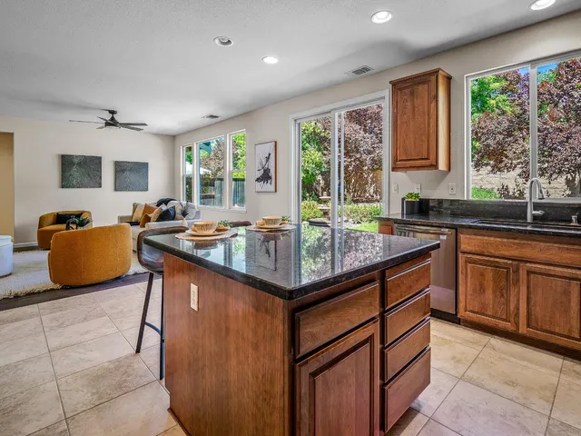 a kitchen with granite countertop a sink and a stove