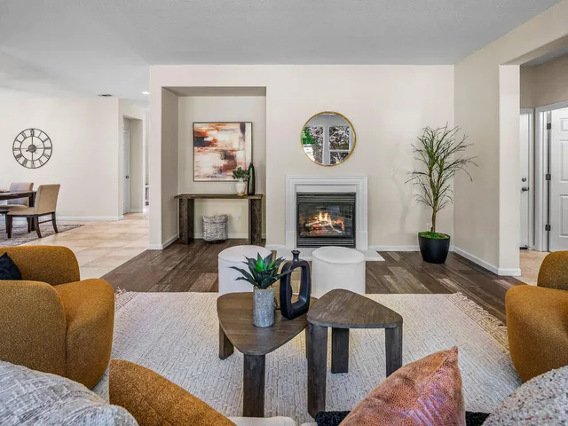 a living room with furniture kitchen view and a fireplace