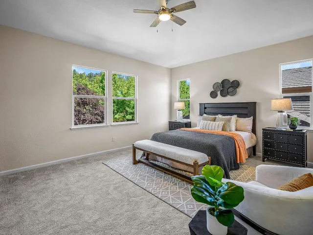 a bedroom with a bed and ceiling fan
