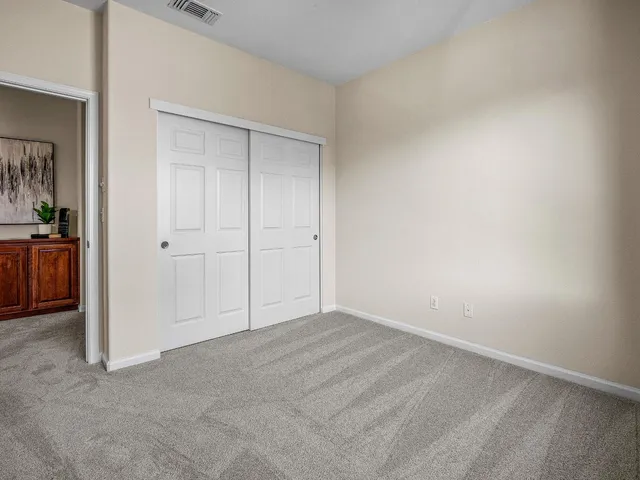 an empty room with closet area