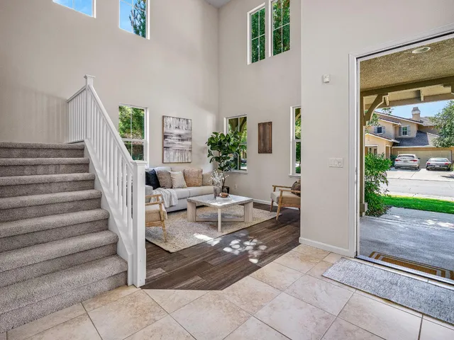 a view of a livingroom with furniture and staircase