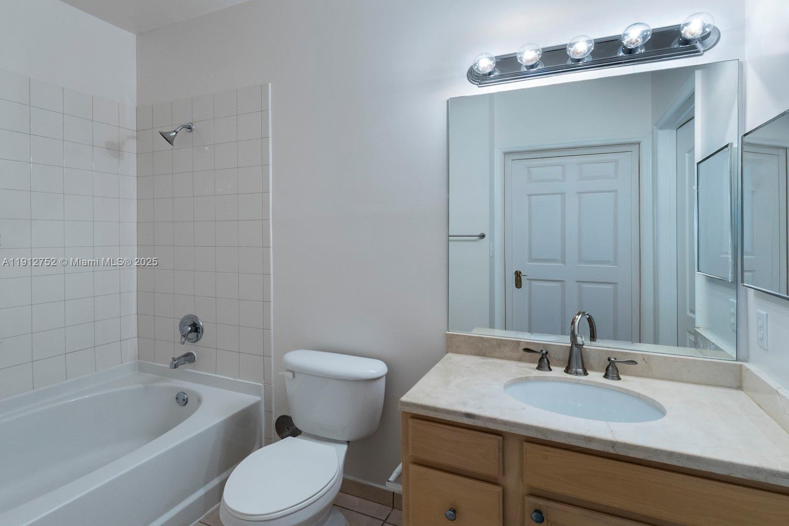 6001 Southwest 70th Street, Unit 139 South Miami, FL 33143 - Photo 18 of 29 a bathroom with a sink toilet and shower