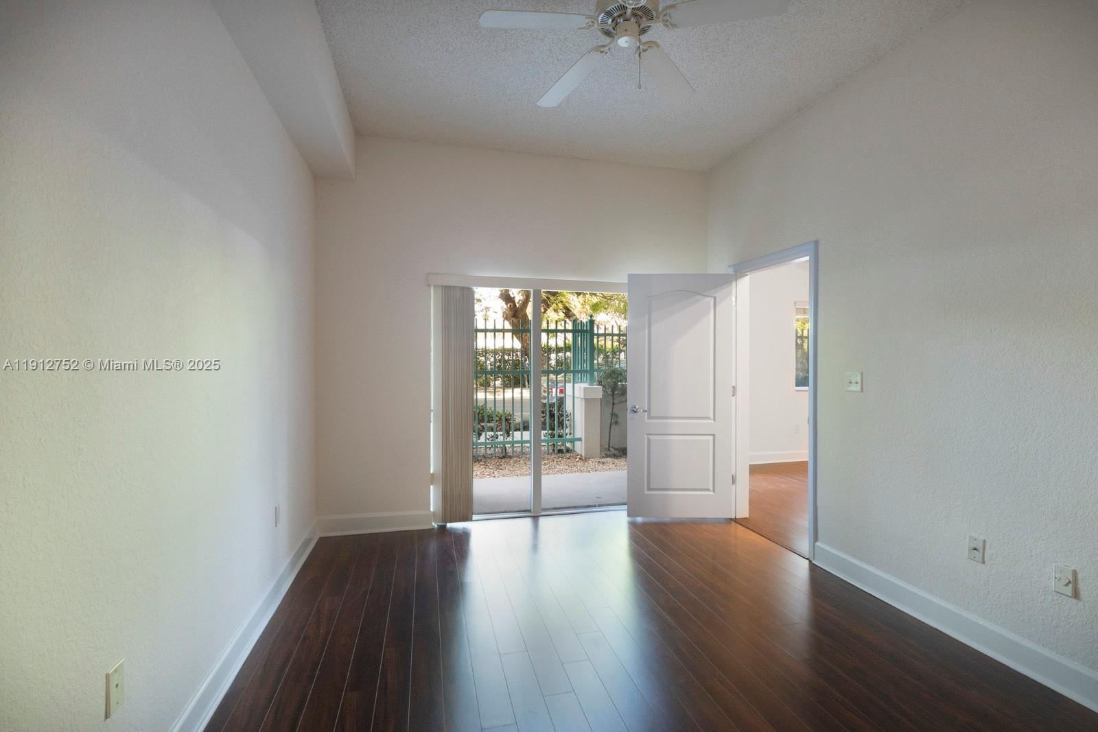 6001 Southwest 70th Street, Unit 139 South Miami, FL 33143 - Photo 19 of 29 an empty room with wooden floor and windows