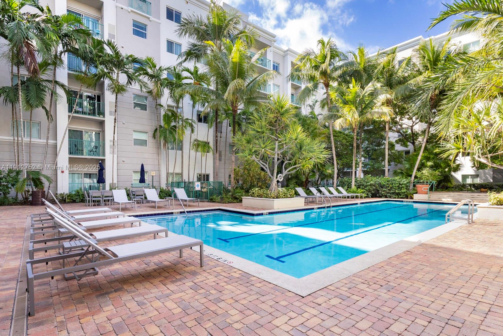 6001 Southwest 70th Street, Unit 139 South Miami, FL 33143 - Photo 23 of 29 a view of a house with swimming pool and sitting area