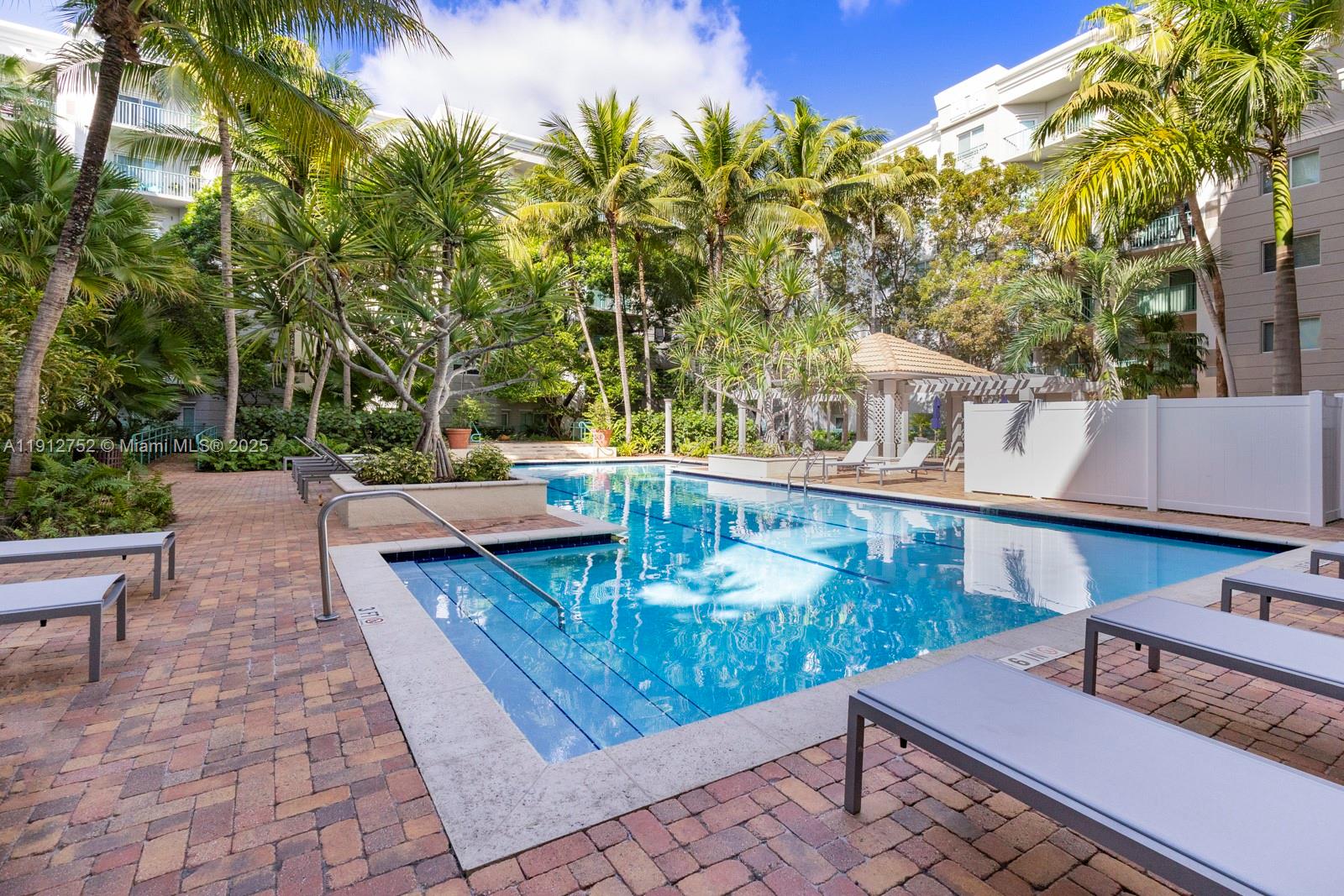 6001 Southwest 70th Street, Unit 139 South Miami, FL 33143 - Photo 24 of 29 a view of a patio with table and chairs and potted plants