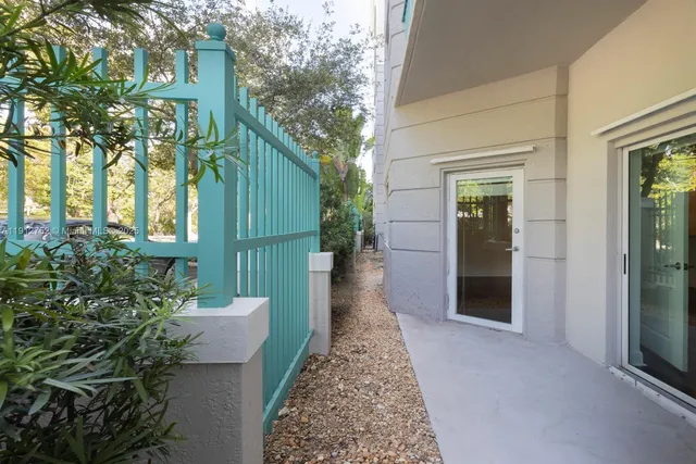 a view of a pathway of the house with potted plants