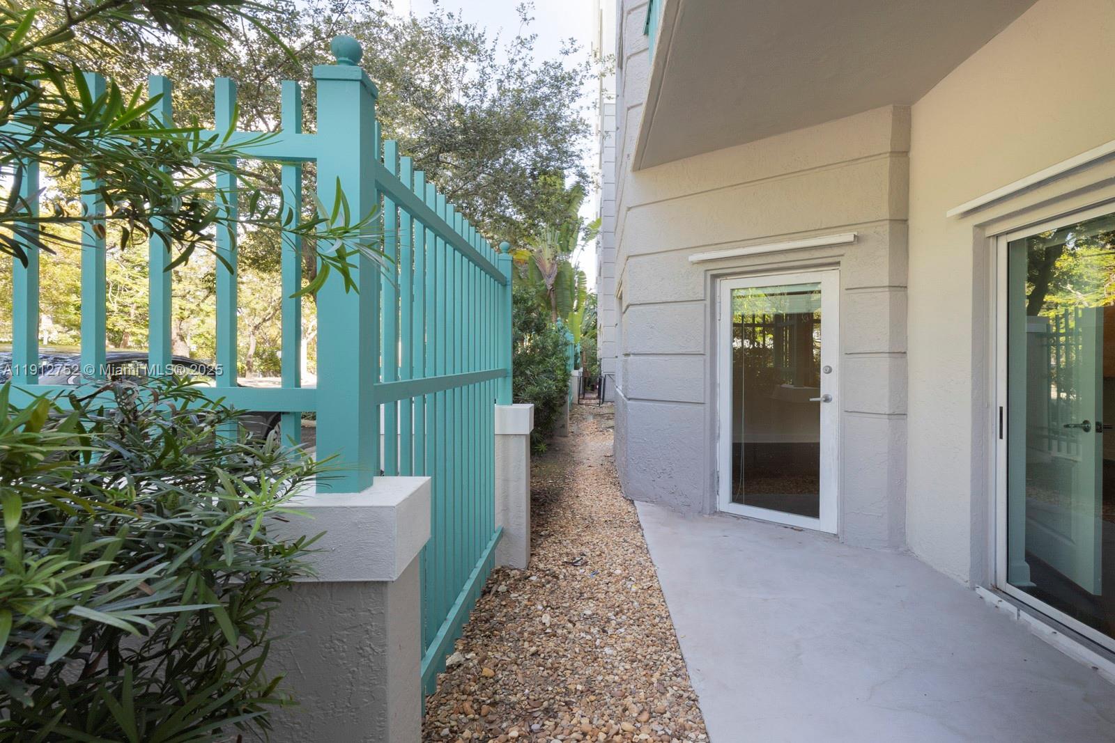 6001 Southwest 70th Street, Unit 139 South Miami, FL 33143 - Photo 6 of 29 a view of a pathway of the house with potted plants