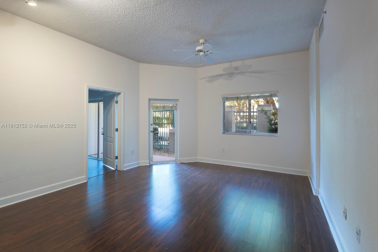 6001 Southwest 70th Street, Unit 139 South Miami, FL 33143 - Photo 10 of 29 an empty room with wooden floor and windows