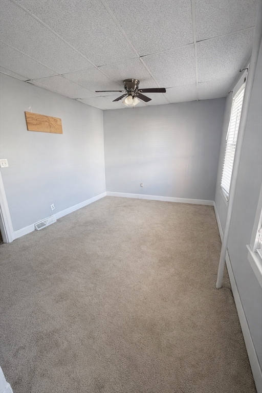 67 Prospect Street Somerville, MA 02143 - Photo 11 of 11 an empty room with a ceiling fan and window