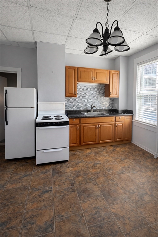 67 Prospect Street Somerville, MA 02143 - Photo 7 of 11 a kitchen with stainless steel appliances granite countertop a sink a stove top oven a counter space and cabinets