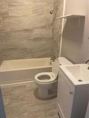 a bathroom with a toilet and a bathtub