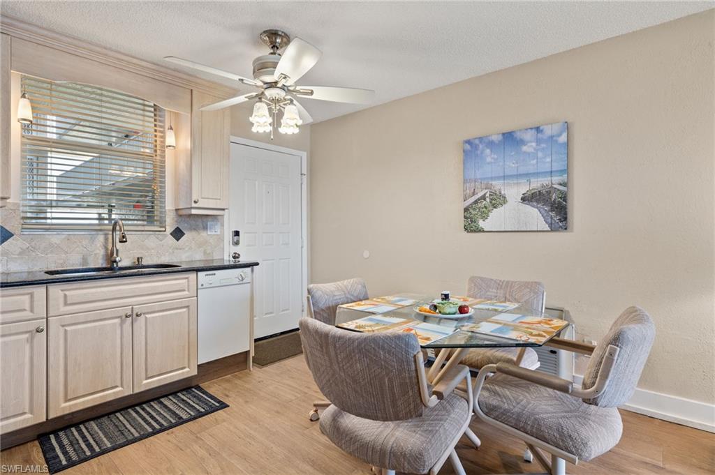 5500 Bonita Beach Road Southwest, Unit 208 Bonita Springs, FL 34134 - Photo 4 of 14 a view of a dining room with furniture window and wooden floor