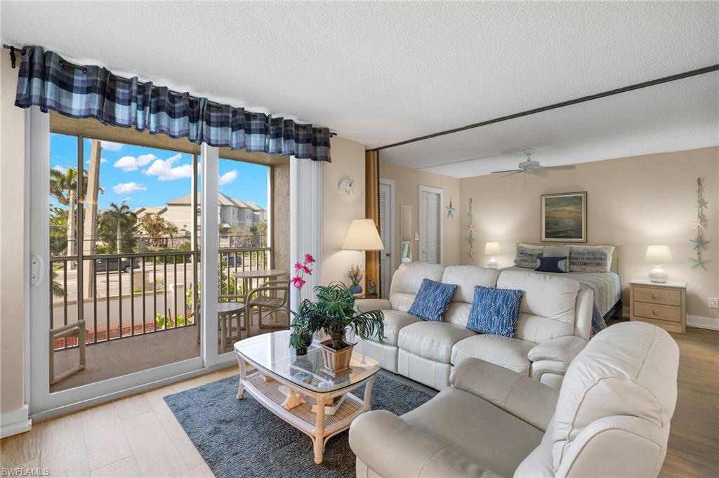 5500 Bonita Beach Road Southwest, Unit 208 Bonita Springs, FL 34134 - Photo 7 of 14 a living room with furniture and a large window