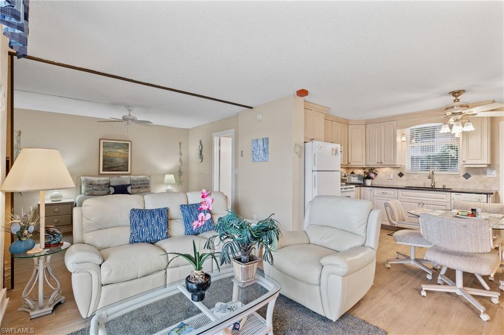 5500 Bonita Beach Road Southwest, Unit 208 Bonita Springs, FL 34134 - Photo 8 of 14 a living room with furniture and a large window