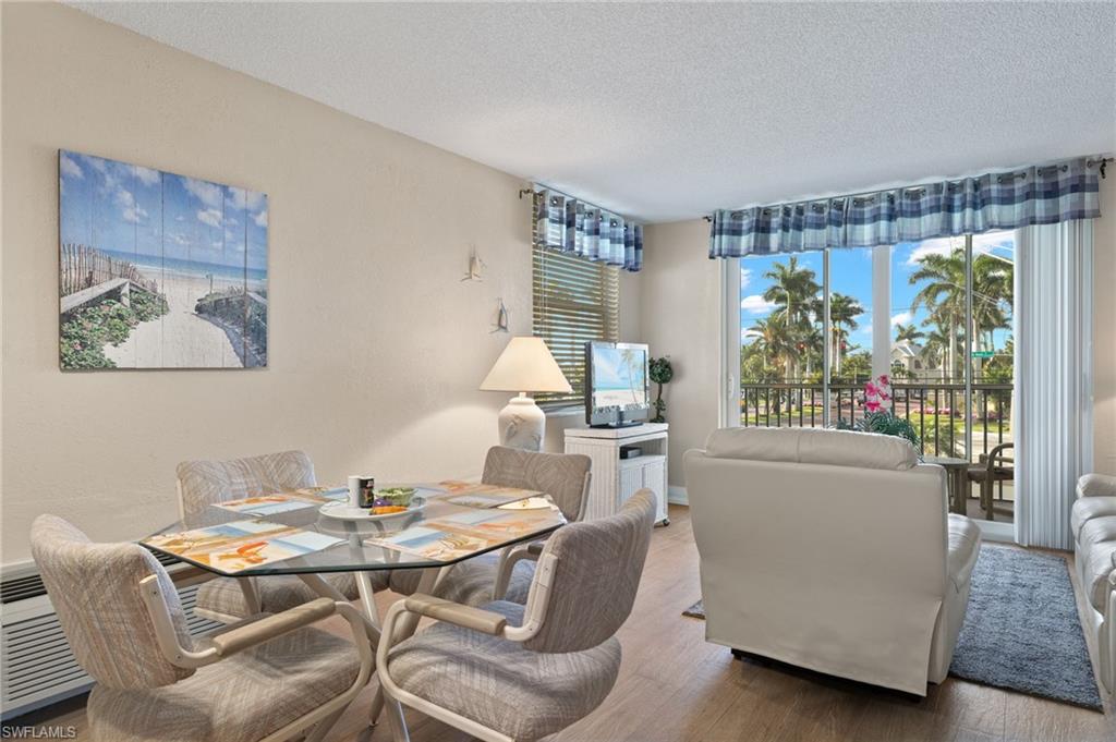 5500 Bonita Beach Road Southwest, Unit 208 Bonita Springs, FL 34134 - Photo 9 of 14 a living room with furniture and a large window