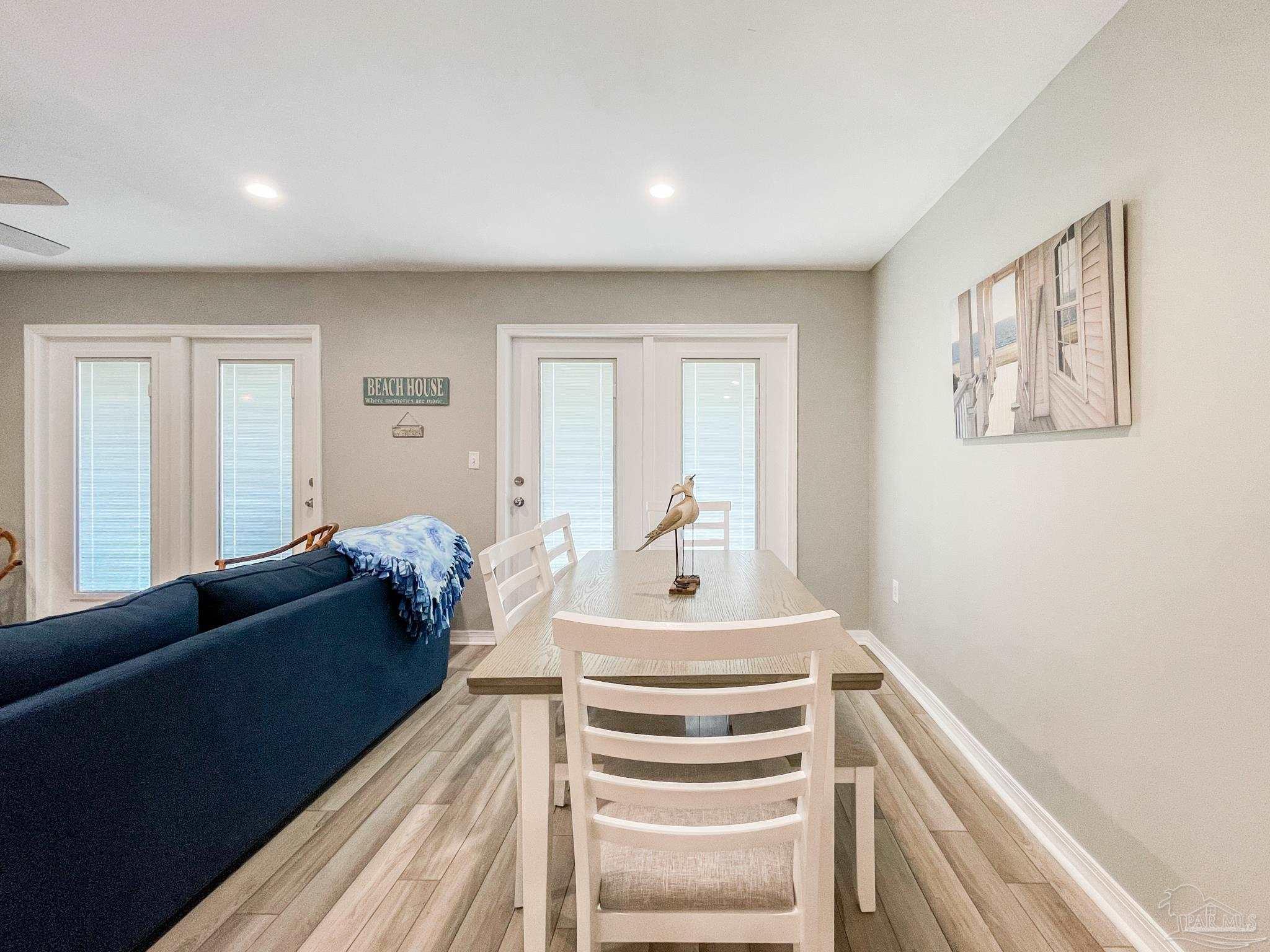13351 Johnson Beach Road, Unit 402E Pensacola, FL 32507 - Photo 14 of 30 a living room with furniture and wooden floor