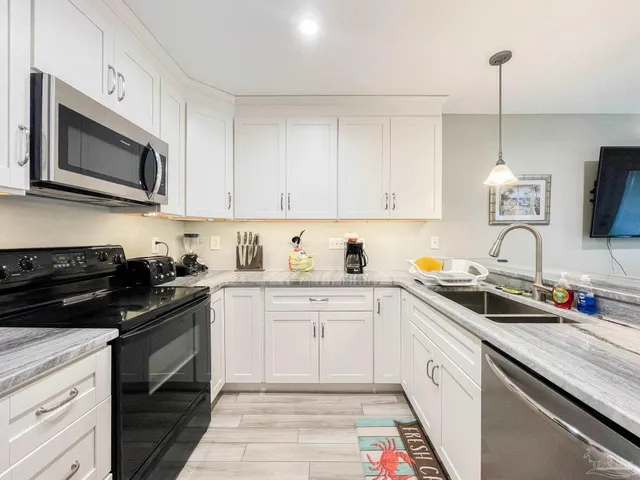 a kitchen with a sink stove and microwave